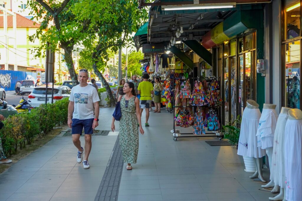 Chenang beach area, shops and hotels, people walking down the street